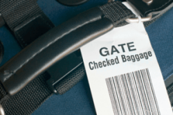 Baggage check tag on luggage.