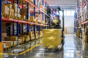 Man operating a forklift in a warehouse.