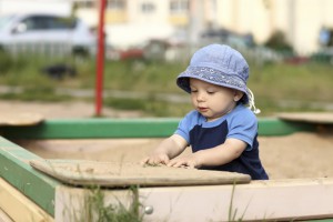 child playing in a sandbox 